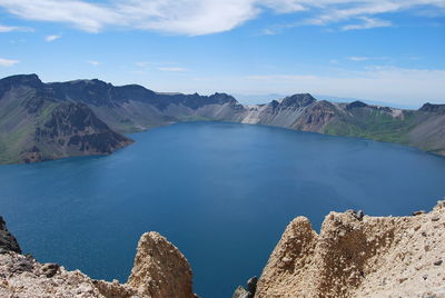 Scenic view of lake and mountains against sky 