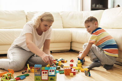 High angle view of boy playing with toys on bed at home