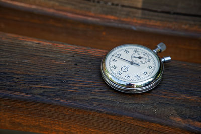 High angle view of stopwatch on wood