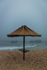 Lifeguard hut on beach against clear sky