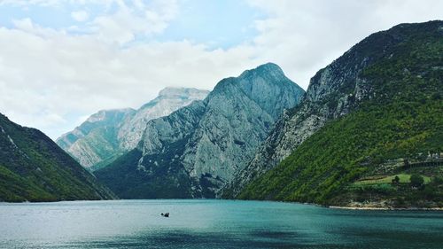 Scenic view of lake against cloudy sky