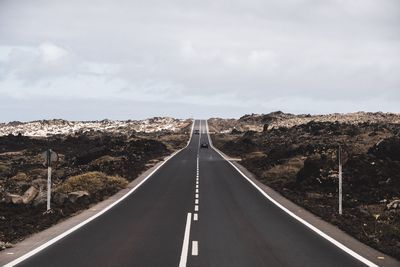 Road amidst landscape against sky