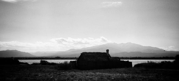 Abandoned built structure on field against sky