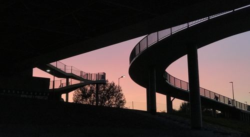 Low angle view of silhouette bridge against sky during sunset