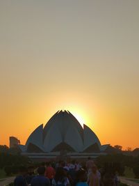 Group of people against clear sky during sunset