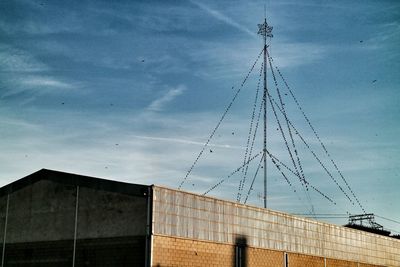 Low angle view of building against cloudy sky