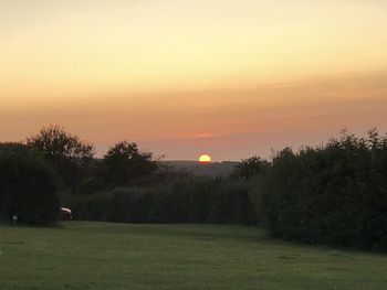 Scenic view of field against sky during sunset