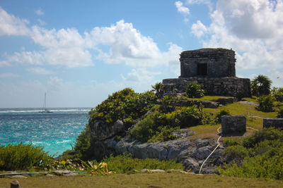 Old ruin on shore against sky