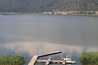 High angle view of lake and boats by trees