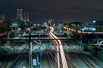 High angle view of light trails on railways in city