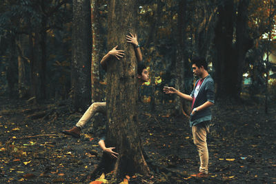 Side view of people walking in forest