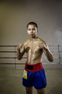 Muay thai boxing athlete standing in ring