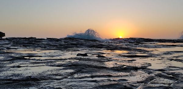 Scenic view of sea against clear sky during sunset