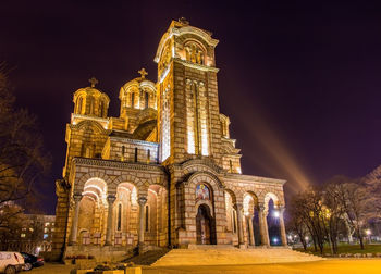 Low angle view of illuminated building against sky at night