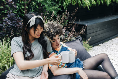 Young couple sitting on table outdoors