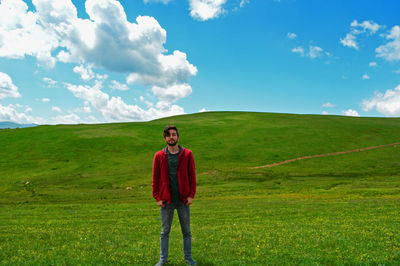 Full length of man standing on field against sky