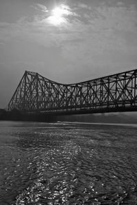 View of bridge over sea against cloudy sky