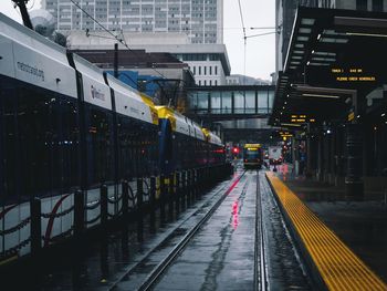 Trains on wet railroad tracks in city