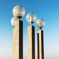 Low angle view of street light against blue sky