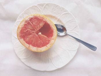 High angle view of grapefruit served in plate on table