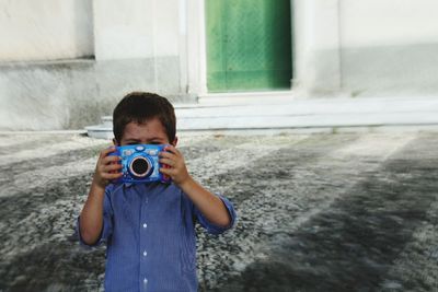 Portrait of boy photographing