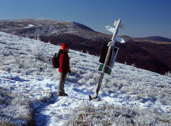 Full length of man standing on snow against sky