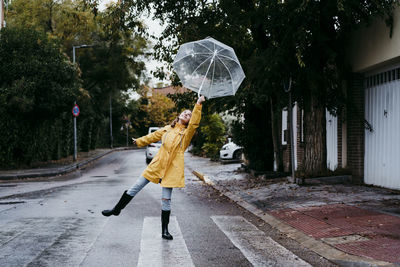 Rear view of person walking on wet street