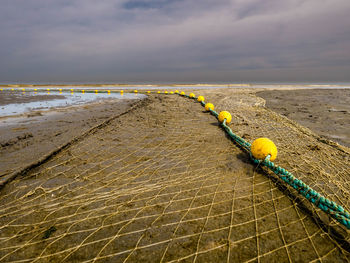 Fishnet layed out at the beach drying