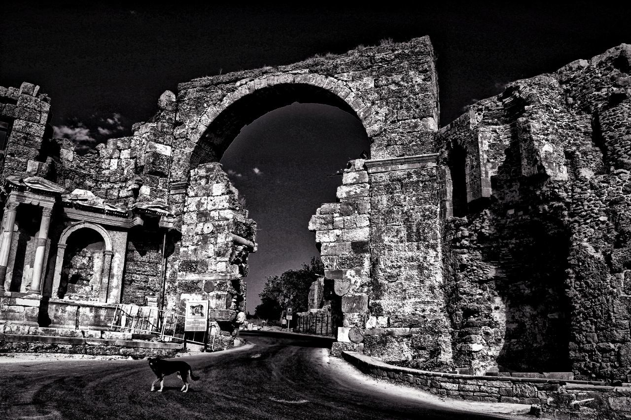 architecture, built structure, building exterior, arch, history, clear sky, night, old, the way forward, stone wall, the past, ancient, archway, entrance, old ruin, outdoors, travel destinations, building, historic, road