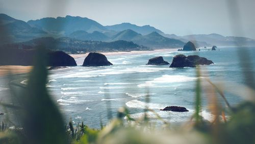 Scenic view of sea and mountains against sky