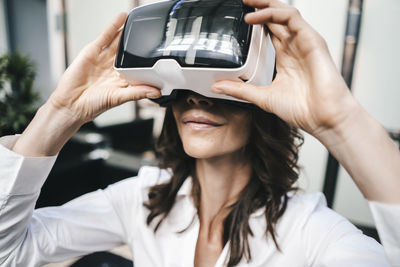 Businesswoman using vr goggles in office