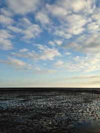Scenic view of sea against cloudy sky