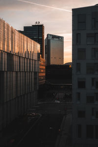 Modern buildings in city during sunset