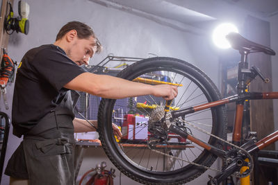 Man working on bicycle wheel