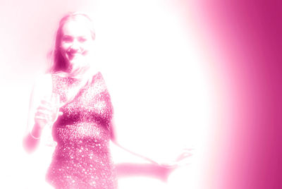 Woman holding camera over white background