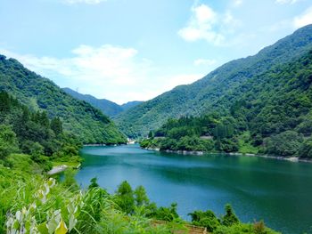 Scenic view of lake and mountains against sky