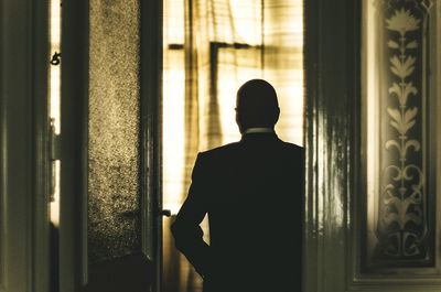 Man looking through window