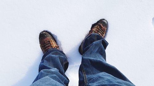 Low section of man standing in snow