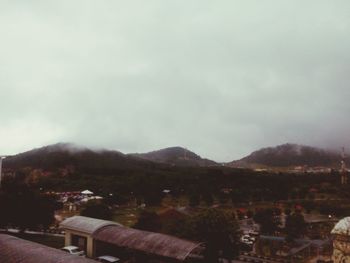 Scenic view of mountains against cloudy sky