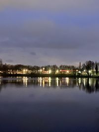 Scenic view of lake against sky at night