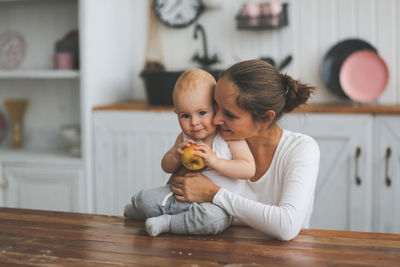 Portrait of cute baby girl sitting at home