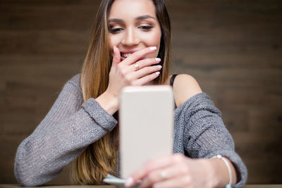 Close-up of young woman using mobile phone