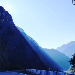 Scenic view of snowcapped mountains against clear blue sky