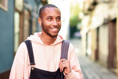 Portrait of smiling young man standing outdoors