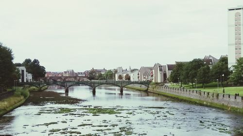 Bridge over river with buildings in background