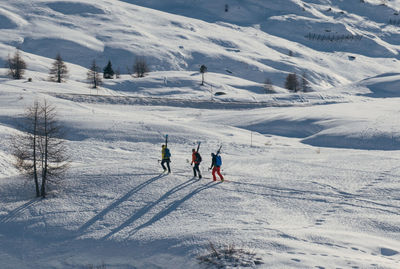 People skiing on snowcapped mountain