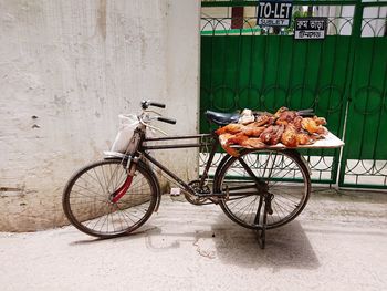 Bicycles on street against wall