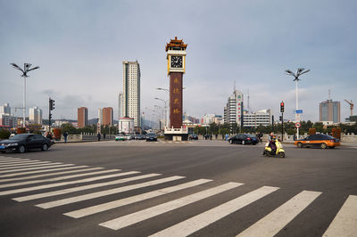 City street and buildings against sky