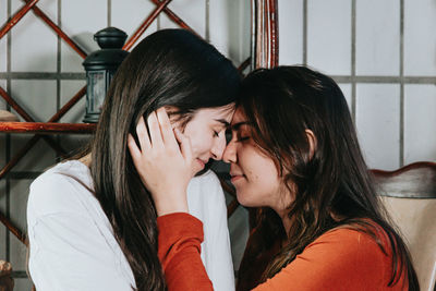 Lesbian women embracing at home