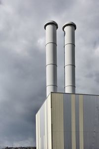 Low angle view of smoke stack against sky